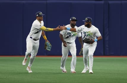 Mar 30, 2023; St. Petersburg, Florida, USA; Tampa Bay Rays center fielder Jose Siri (22), left fielder Randy Arozarena (56) and right fielder Manuel Margot (13) celebrate after they beat the Detroit Tigers at Tropicana Field. Mandatory Credit: Kim Klement-USA TODAY Sports