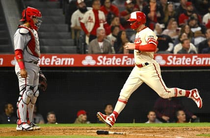Apr 11, 2023; Anaheim, California, USA;  Washington Nationals catcher Keibert Ruiz (20) looks on as Los Angeles Angels left fielder Taylor Ward (3) crosses the plate to score a run on a sacrifice fly by third baseman Anthony Rendon (6) in the fourth inning at Angel Stadium. Mandatory Credit: Jayne Kamin-Oncea-USA TODAY Sports