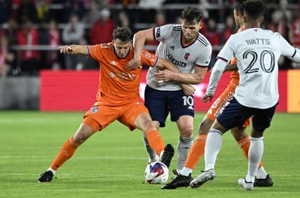 Apr 15, 2023; St. Louis, Missouri, USA; FC Cincinnati defender Santiago Arias (13) and St. Louis City midfielder Eduard Lowen (10) battle for the ball during the second half at CITYPARK. Mandatory Credit: Scott Rovak-USA TODAY Sports