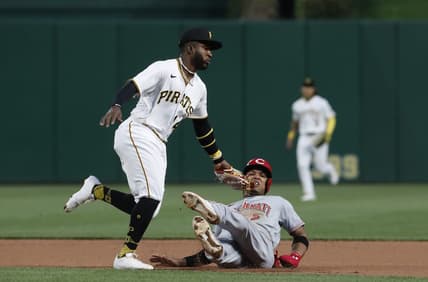 Apr 22, 2023; Pittsburgh, Pennsylvania, USA;  Cincinnati Reds  center fielder Jose Barrero (2) is tagged out between first and second base by Pittsburgh Pirates second baseman Rodolfo Castro (14) as Barrero attempts to steal second base during the fourth inning at PNC Park. Mandatory Credit: Charles LeClaire-USA TODAY Sports