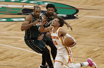 Apr 25, 2023; Boston, Massachusetts, USA; Atlanta Hawks guard Trae Young (11) gets fouled by Boston Celtics center Al Horford (42) during the fourth quarter of game five of the 2023 NBA playoffs at TD Garden. Mandatory Credit: Winslow Townson-USA TODAY Sports