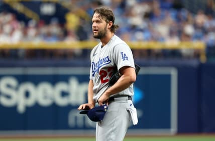 May 27, 2023; St. Petersburg, Florida, USA; Los Angeles Dodgers starting pitcher Clayton Kershaw (22) reacts after he balked and puts the transmitter in his hat during the first inning against the Tampa Bay Rays  at Tropicana Field. Mandatory Credit: Kim Klement-USA TODAY Sports