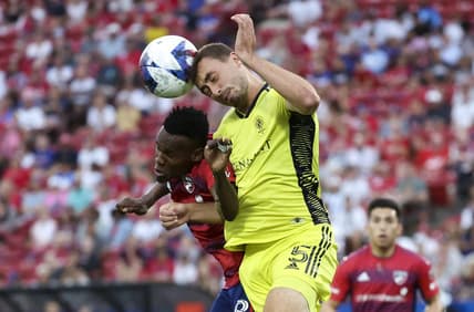 Jun 3, 2023; Frisco, Texas, USA;  Nashville SC defender Jack Maher (5) heads the ball away from FC Dallas forward Jader Obrian (8) during the first half at Toyota Stadium. Mandatory Credit: Kevin Jairaj-USA TODAY Sports