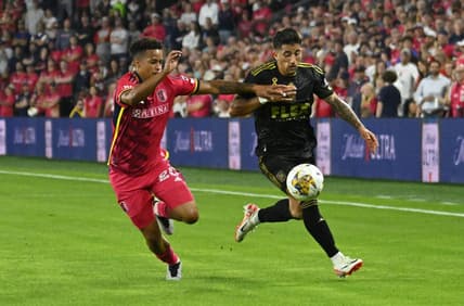 Sep 20, 2023; St. Louis, Missouri, USA; St. Louis City defender Akil Watts (20) and Los Angeles FC midfielder Cristian Olivera (25) chase a loose ball during the first half at CITYPARK. Mandatory Credit: Scott Rovak-USA TODAY Sports