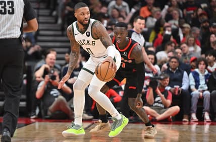 Nov 15, 2023; Toronto, Ontario, CAN;  Milwaukee Bucks guard Damian Lillard (0) controls the ball as Toronto Raptors guard Dennis Schroder (17) defends in the first half at Scotiabank Arena. Mandatory Credit: Dan Hamilton-USA TODAY Sports