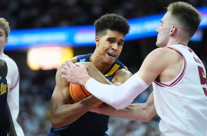 Dec 2, 2023; Madison, Wisconsin, USA;  Marquette Golden Eagles forward Oso Ighodaro (13) and Wisconsin Badgers forward Tyler Wahl (5) battle for the ball during the second half at the Kohl Center. Mandatory Credit: Kayla Wolf-USA TODAY Sports