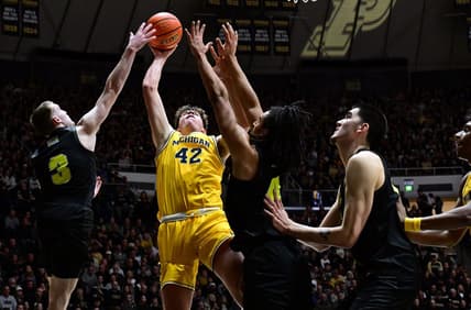 Jan 23, 2024; West Lafayette, Indiana, USA; Michigan Wolverines forward Will Tschetter (42) has a shot blocked by Purdue Boilermakers guard Braden Smith (3) during the first half at Mackey Arena. Mandatory Credit: Marc Lebryk-USA TODAY Sports