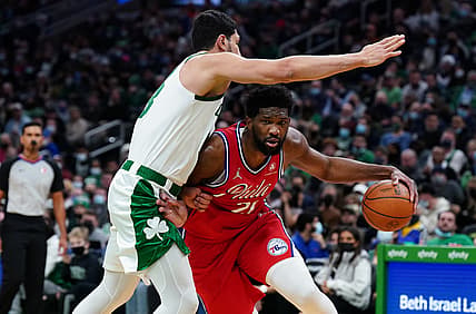 Dec 20, 2021; Boston, Massachusetts, USA; Philadelphia 76ers center Joel Embiid (21) drives the ball against Boston Celtics center Enes Freedom (13) in the second quarter at TD Garden. Mandatory Credit: David Butler II-USA TODAY Sports