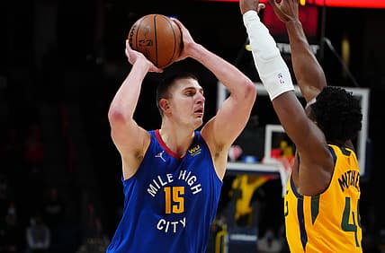 Jan 5, 2022; Denver, Colorado, USA; Denver Nuggets center Nikola Jokic (15) attempts to pass over Utah Jazz guard Donovan Mitchell (45) in the second half at Ball Arena. Mandatory Credit: Ron Chenoy-USA TODAY Sports