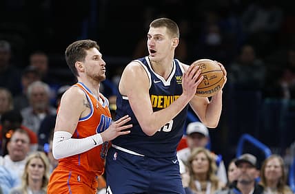 Jan 9, 2022; Oklahoma City, Oklahoma, USA; Denver Nuggets center Nikola Jokic (15) is defended by Oklahoma City Thunder center Mike Muscala (33) on a drive to the basket during the second half at Paycom Center. Denver won 99-95. Mandatory Credit: Alonzo Adams-USA TODAY Sports