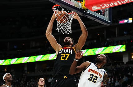 Jan 16, 2022; Denver, Colorado, USA; Utah Jazz center Rudy Gobert (27) dunks the ball over Denver Nuggets forward Jeff Green (32) in the second quarter at Ball Arena. Mandatory Credit: Ron Chenoy-USA TODAY Sports