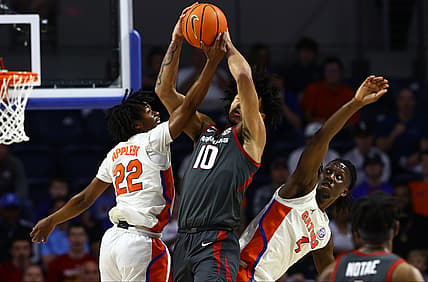Feb 22, 2022; Gainesville, Florida, USA; Florida Gators guard Tyree Appleby (22), Florida Gators forward Anthony Duruji (4) and Arkansas Razorbacks forward Jaylin Williams (10) go after the loose ball during the first half at Billy Donovan Court at Exactech Arena. Mandatory Credit: Kim Klement-USA TODAY Sports
