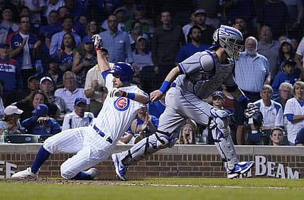 Jul 16, 2022; Chicago, Illinois, USA; Chicago Cubs third baseman Patrick Wisdom (16) scores as New York Mets catcher Tomas Nido (3) waits for a late throw during the fourth inning in game two of a doubleheader at Wrigley Field. Mandatory Credit: David Banks-USA TODAY Sports