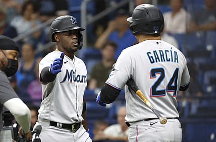 May 25, 2022; St. Petersburg, Florida, USA; Miami Marlins right fielder Jorge Soler (12) is congratulated by right fielder Avisail Garcia (24) as he hits a home run during the fourth inning against the Tampa Bay Rays  at Tropicana Field. Mandatory Credit: Kim Klement-USA TODAY Sports