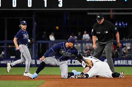 Aug 31, 2022; Miami, Florida, USA; Miami Marlins third baseman Jon Berti (5) steals second base ahead of the tag of Tampa Bay Rays second baseman Brandon Lowe (8) in the fourth inning at loanDepot park. Mandatory Credit: Jasen Vinlove-USA TODAY Sports