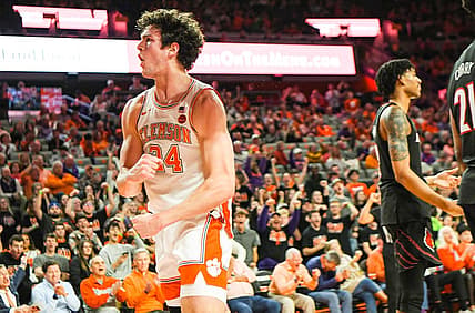 Jan 11, 2023; Clemson, South Carolina, USA; Clemson Tigers forward PJ Hall (24) celebrates near Louisville Cardinals forward Sydney Curry (21) after scoring and being fouled during the second half at Littlejohn Coliseum. Mandatory Credit: Ken Ruinard-USA TODAY Sports