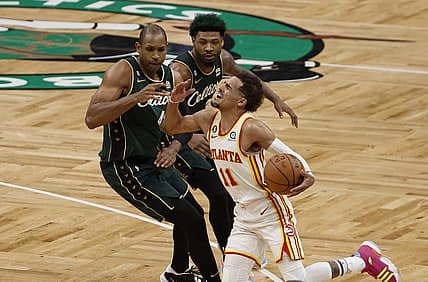 Apr 25, 2023; Boston, Massachusetts, USA; Atlanta Hawks guard Trae Young (11) gets fouled by Boston Celtics center Al Horford (42) during the fourth quarter of game five of the 2023 NBA playoffs at TD Garden. Mandatory Credit: Winslow Townson-USA TODAY Sports