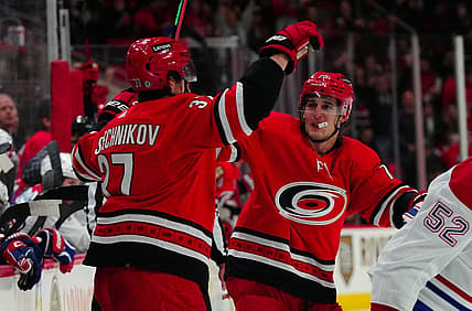 Dec 28, 2023; Raleigh, North Carolina, USA; Carolina Hurricanes right wing Andrei Svechnikov (37) celebrates his goal with defenseman Brady Skjei (76) against the Montreal Canadiens during the third period at PNC Arena. Mandatory Credit: James Guillory-USA TODAY Sports