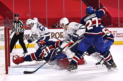 Feb 20, 2021; Montreal, Quebec, CAN; Montreal Canadiens goaltender Carey Price (31) makes a save against Toronto Maple Leafs right wing Ilya Mikheyev (65) and left wing Zach Hyman (11) and defenseman Alexander Romanov (27) during the first period at Bell Centre. Mandatory Credit: Jean-Yves Ahern-USA TODAY Sports