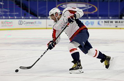 Mar 15, 2021; Buffalo, New York, USA;  Washington Capitals left wing Alex Ovechkin (8) takes a shot on goal during the first period against the Buffalo Sabres at KeyBank Center. Mandatory Credit: Timothy T. Ludwig-USA TODAY Sports
