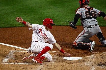 Apr 20, 2021; Philadelphia, Pennsylvania, USA; Philadelphia Phillies center fielder Mickey Moniak (16) slides past San Francisco Giants catcher Buster Posey (28) to score a run in the second inning at Citizens Bank Park. Mandatory Credit: Kyle Ross-USA TODAY Sports