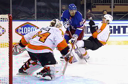 Apr 23, 2021; New York, New York, USA; Robert Hagg #8 of the Philadelphia Flyers bounces off Pavel Buchnevich #89 of the New York Rangers during the second period at Madison Square Garden. Mandatory Credit:  Bruce Bennett/POOL PHOTOS-USA TODAY Sports