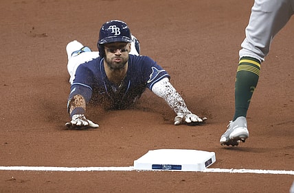 Apr 27, 2021; St. Petersburg, Florida, USA; Tampa Bay Rays center fielder Kevin Kiermaier (39) slides into third base as he triples during the first inning against the Oakland Athletics at Tropicana Field. Mandatory Credit: Kim Klement-USA TODAY Sports