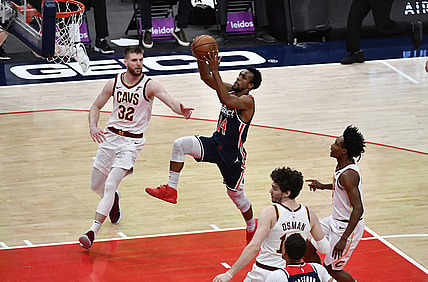 May 14, 2021; Washington, District of Columbia, USA; Washington Wizards guard Ish Smith (14) shoots as Cleveland Cavaliers forward Dean Wade (32) looks on during the second quarter at Capital One Arena. Mandatory Credit: Brad Mills-USA TODAY Sports