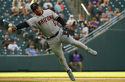 May 21, 2021; Denver, Colorado, USA; Arizona Diamondbacks third baseman Eduardo Escobar (5) fields the ball in the first inning against the Colorado Rockies at Coors Field. Mandatory Credit: Ron Chenoy-USA TODAY Sports
