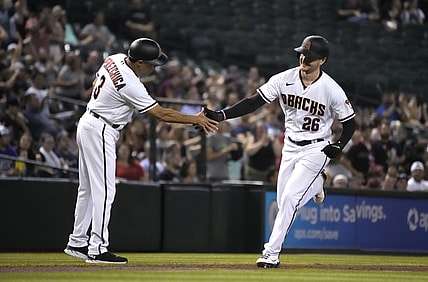 Jul 19, 2021; Phoenix, Arizona, USA; Arizona Diamondbacks first baseman Pavin Smith (26) celebrates with third base coach Tony Perezchica (3) after hitting a home run against the Pittsburgh Pirates in the second inning at Chase Field. Mandatory Credit: Rick Scuteri-USA TODAY Sports