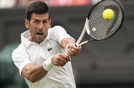Jun 27, 2022; London, United Kingdom;  Novak Djokovic (SRB) returns a shot during his first round match against Soonwoo Kwon (KOR) on day one at All England Lawn Tennis and Croquet Club. Mandatory Credit: Susan Mullane-USA TODAY Sports