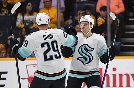 Mar 25, 2023; Nashville, Tennessee, USA; Seattle Kraken right wing Eeli Tolvanen (20) celebrates with defenseman Vince Dunn (29) after a goal during the first period against the Nashville Predators at Bridgestone Arena. Mandatory Credit: Christopher Hanewinckel-USA TODAY Sports