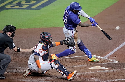 Oct 23, 2023; Houston, Texas, USA; Texas Rangers right fielder Adolis Garcia (53) hits a home run during the third inning of game seven in the ALCS against the Houston Astros for the 2023 MLB playoffs at Minute Maid Park. Mandatory Credit: Erik Williams-USA TODAY Sports
