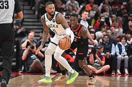 Nov 15, 2023; Toronto, Ontario, CAN;  Milwaukee Bucks guard Damian Lillard (0) controls the ball as Toronto Raptors guard Dennis Schroder (17) defends in the first half at Scotiabank Arena. Mandatory Credit: Dan Hamilton-USA TODAY Sports
