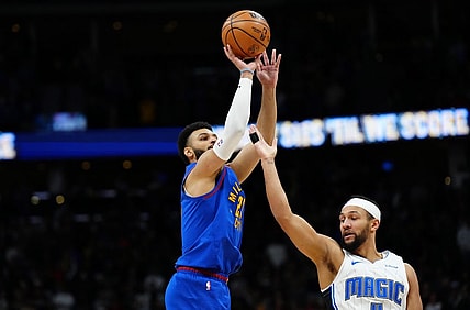Jan 5, 2024; Denver, Colorado, USA; Denver Nuggets guard Jamal Murray (27) shoots over Orlando Magic guard Jalen Suggs (4) in the first quarter at Ball Arena. Mandatory Credit: Ron Chenoy-USA TODAY Sports