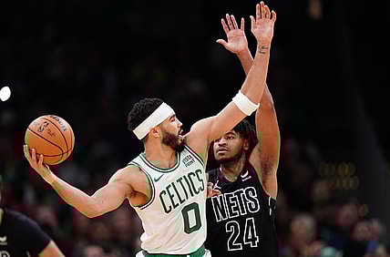 Feb 14, 2024; Boston, Massachusetts, USA; Boston Celtics forward Jayson Tatum (0) looks for an opening against Brooklyn Nets guard Cam Thomas (24) in the second half at TD Garden. Mandatory Credit: David Butler II-USA TODAY Sports