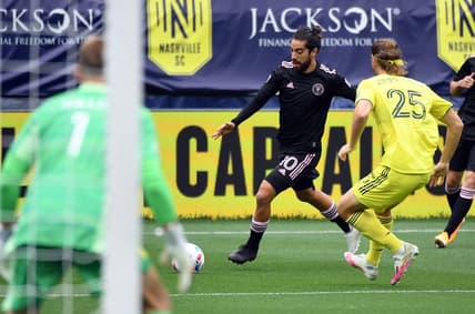 May 2, 2021; Nashville, TN, USA; Inter Miami midfielder Rodolfo Pizarro (10) plays the ball in the box as he is defended by Nashville SC defender Walker Zimmerman (25) during the first half at Nissan Stadium. Mandatory Credit: Christopher Hanewinckel-USA TODAY Sports