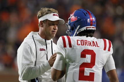 Oct 30, 2021; Auburn, Alabama, USA; Mississippi Rebels head coach Lane Kiffin talks with quarterback Matt Corral (2) during the second quarter against the Auburn Tigers at Jordan-Hare Stadium.  Mandatory Credit: John Reed-USA TODAY Sports