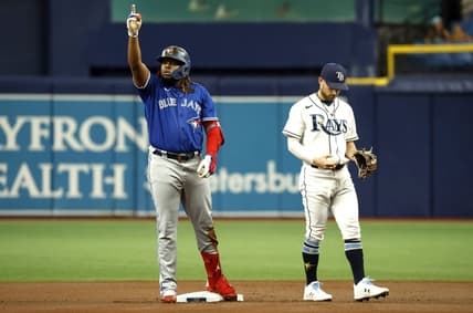 Aug 2, 2022; St. Petersburg, Florida, USA; Toronto Blue Jays first baseman Vladimir Guerrero Jr. (27) celebrates after hitting a double as Tampa Bay Rays second baseman Brandon Lowe (8) looks down during the first inning at Tropicana Field. Mandatory Credit: Kim Klement-USA TODAY Sports