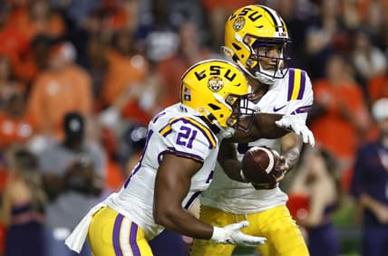 Oct 1, 2022; Auburn, Alabama, USA;  LSU Tigers quarterback Jayden Daniels (5) hands off to running back Noah Cain (21) during the third quarter against the Auburn Tigers at Jordan-Hare Stadium. Mandatory Credit: John Reed-USA TODAY Sports
