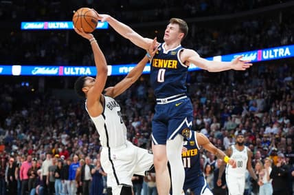 Mar 12, 2023; Denver, Colorado, USA; Denver Nuggets guard Christian Braun (0) blocks the shot of Brooklyn Nets guard Seth Curry (30) in the fourth quarter at Ball Arena. Mandatory Credit: Ron Chenoy-USA TODAY Sports