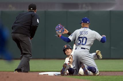 Apr 10, 2023; San Francisco, California, USA; Los Angeles Dodgers second baseman Mookie Betts (50) tags out San Francisco Giants right fielder Mike Yastrzemski (5) as he is caught attempting to steal second base during the first inning at Oracle Park. Umpire is Alex Tosi. Mandatory Credit: D. Ross Cameron-USA TODAY Sports
