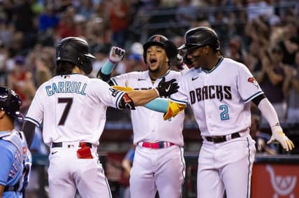 Jun 27, 2023; Phoenix, Arizona, USA; Arizona Diamondbacks outfielder Corbin Carroll (7) celebrates with teammates Geraldo Perdomo (2) and Ketel Marte after hitting a three run home run in the first inning against the Tampa Bay Rays at Chase Field. Mandatory Credit: Mark J. Rebilas-USA TODAY Sports