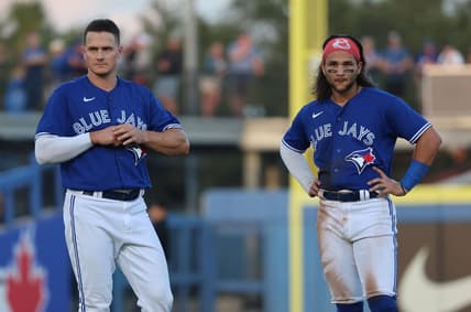 Mar 25, 2023; Dunedin, Florida, USA; Toronto Blue Jays third baseman Matt Chapman (26) and shortstop Bo Bichette (11) look on against the Detroit Tigers  at TD Ballpark. Mandatory Credit: Kim Klement-USA TODAY Sports