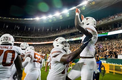 Texas offensive lineman Kelvin Banks Jr. (78) and Texas running back CJ Baxter (4) celebrate a touchdown against Baylor in the second half of an NCAA college football game, Saturday, Sept. 23, 2023, in Waco, Texas.