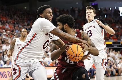 Mar 5, 2022; Auburn, Alabama, USA; Auburn Tigers guard K.D. Johnson (0) tries to get the ball from South Carolina Gamecocks forward Ta'Quan Woodley (55) during the first half at Neville Arena. Mandatory Credit: John Reed-USA TODAY Sports