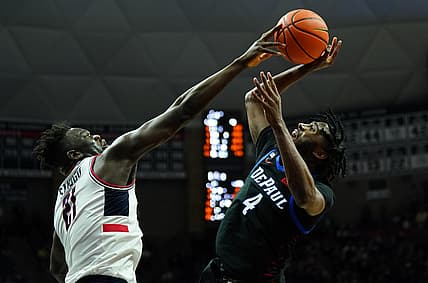 Mar 5, 2022; Storrs, Connecticut, USA; Connecticut Huskies forward Adama Sanogo (21) defends against  DePaul Blue Demons guard Javon Freeman-Liberty (4) in the second half at Harry A. Gampel Pavilion. Mandatory Credit: David Butler II-USA TODAY Sports