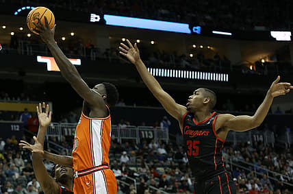 Mar 20, 2022; Pittsburgh, PA, USA; Illinois Fighting Illini center Kofi Cockburn (21) shoots the ball against Houston Cougars forward Fabian White Jr. (35) in the second half during the second round of the 2022 NCAA Tournament at PPG Paints Arena. Mandatory Credit: Charles LeClaire-USA TODAY Sports