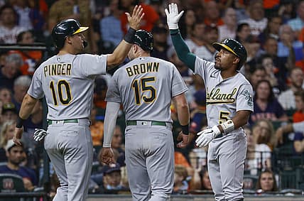 Jul 15, 2022; Houston, Texas, USA; Oakland Athletics left fielder Tony Kemp (5) celebrates with designated hitter Chad Pinder (10) and first baseman Seth Brown (15) during the seventh inning against the Houston Astros  at Minute Maid Park. Mandatory Credit: Troy Taormina-USA TODAY Sports