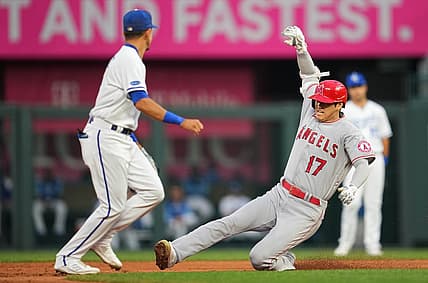 Jul 25, 2022; Kansas City, Missouri, USA; Los Angeles Angels designated hitter Shohei Ohtani (17) slides into second base for a double as Kansas City Royals shortstop Nicky Lopez (left) awaits the throw during the third inning at Kauffman Stadium. Mandatory Credit: Jay Biggerstaff-USA TODAY Sports
